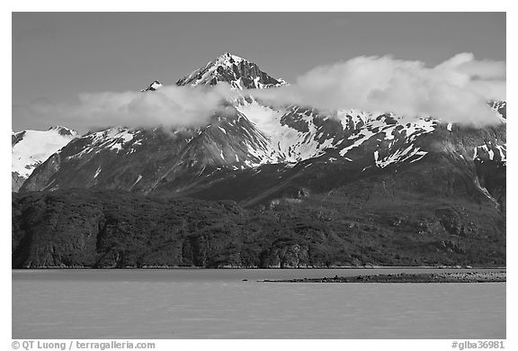 Snowy peaks and clouds raising above turquoise waters in sunny weather. Glacier Bay National Park (black and white)