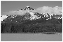 Snowy peaks and clouds raising above turquoise waters in sunny weather. Glacier Bay National Park ( black and white)