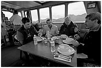 Passengers eating a soup for lunch. Glacier Bay National Park, Alaska, USA. (black and white)