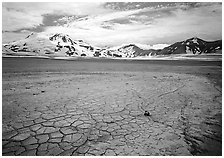 The desert-like floor of the Valley of Ten Thousand smokes is surrounded by snow-covered peaks such as Mt Meigeck. Katmai National Park, Alaska, USA. (black and white)