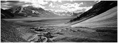 Stream flowing into arid ash-covered valley. Katmai National Park (Panoramic black and white)