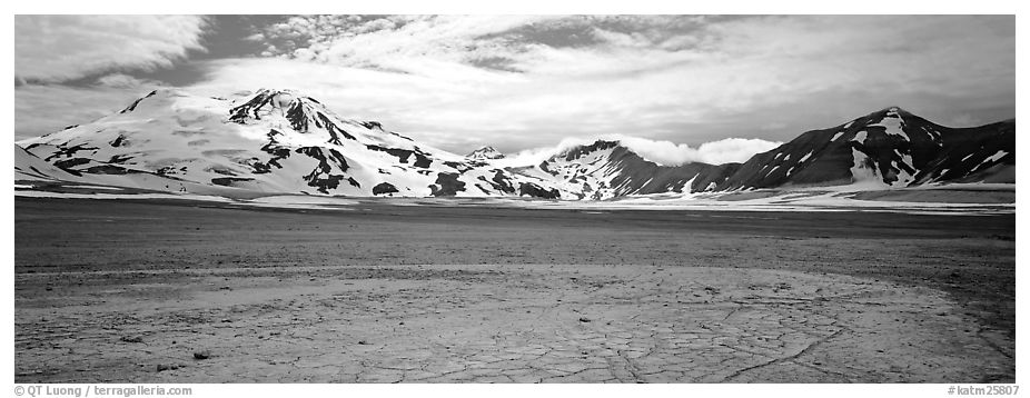 Snow-covered mountains surrounding ash-covered flats. Katmai National Park (black and white)