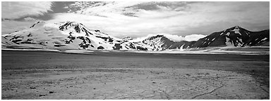 Snow-covered mountains surrounding ash-covered flats. Katmai National Park (Panoramic black and white)