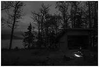 Camper sitting by campfire at night,  Brooks Camp. Katmai National Park ( black and white)