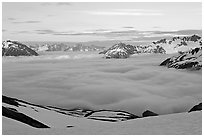 Peaks emerging from clouds at sunset. Kenai Fjords National Park ( black and white)