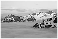 Midnight sunset on peaks above clouds. Kenai Fjords National Park ( black and white)