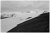 Rocky slope and snow-covered Harding Icefield at dusk. Kenai Fjords National Park, Alaska, USA. (black and white)