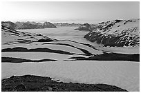 Bands freshly uncovered by snow, and low clouds, sunrise. Kenai Fjords National Park, Alaska, USA. (black and white)