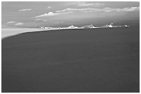 Distant mountains emerging from shadows over the Harding field. Kenai Fjords National Park, Alaska, USA. (black and white)
