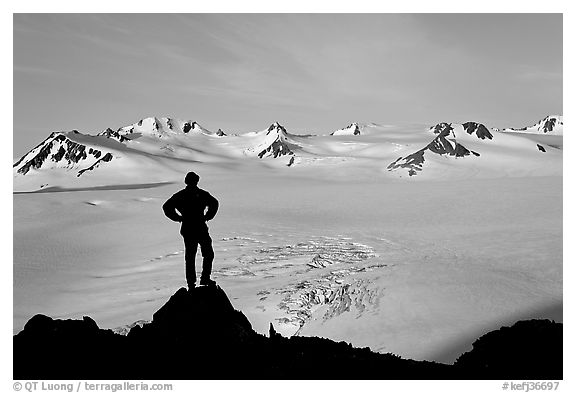 Man standing on overlook above Harding ice field, early morning. Kenai Fjords National Park, Alaska, USA.