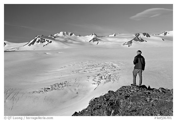 Man looking at the Harding ice field, early morning. Kenai Fjords National Park, Alaska, USA.