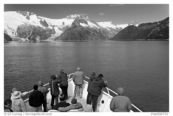 Vistors on bow of tour boat approaching glacier, Northwestern Fjord. Kenai Fjords National Park (black and white)