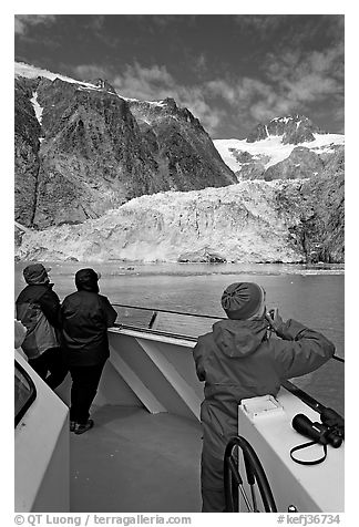 Passengers looking at Northwestern glacier from the deck of tour boat. Kenai Fjords National Park, Alaska, USA.
