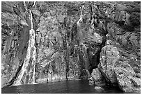 Waterfalls streaming into the ocean, Cataract Cove, Northwestern Fjord. Kenai Fjords National Park ( black and white)