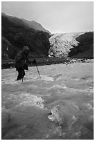 Hiker wades in  glacial stream, Exit Glacier. Kenai Fjords National Park ( black and white)