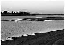 Sand bar shore, river, row of spruce trees,  and Baird mountains, evening. Kobuk Valley National Park ( black and white)
