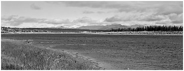 Wide river bordered by grassy banks. Kobuk Valley National Park (Panoramic black and white)