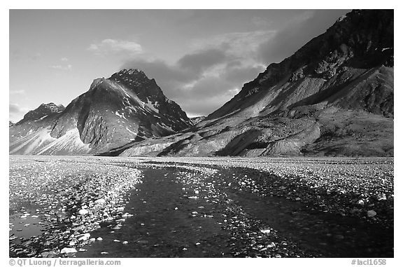 Wide gravel river bar below the Telaquana Mountains, sunset. Lake Clark National Park (black and white)