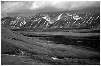 Verdant tundra, lake, and snowy mountains under clouds. Lake Clark National Park, Alaska, USA. (black and white)