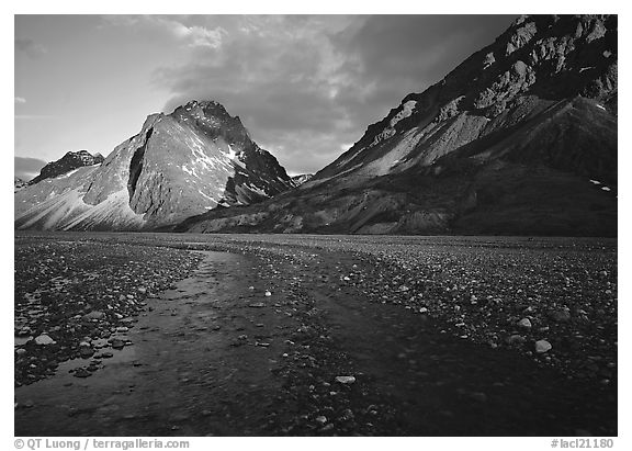 Stream on wide gravel bar and peaks at sunset. Lake Clark National Park (black and white)