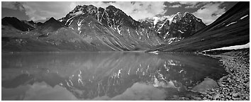 Tall mountains reflected in Turquoise Lake. Lake Clark National Park (Panoramic black and white)