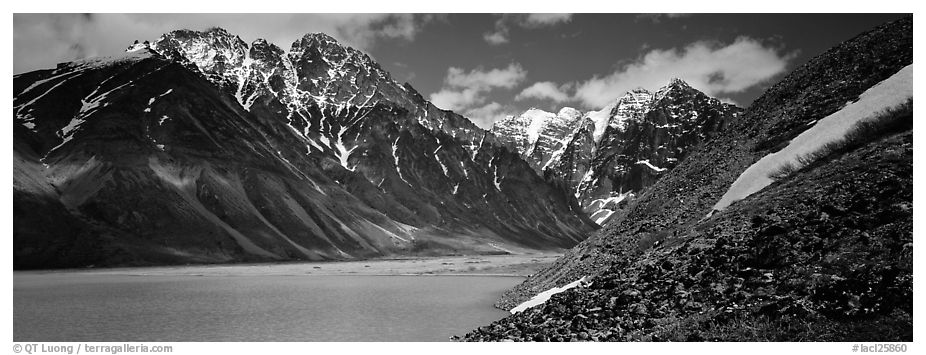 Rugged mountains rising above lake with turquoise waters. Lake Clark National Park (black and white)