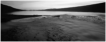 Wide stream flowing into lake at sunset. Lake Clark National Park (Panoramic black and white)