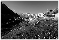 Morainic debris on Root glacier with Wrangell mountains in the background, late afternoon. Wrangell-St Elias National Park ( black and white)