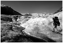 Backpacker with large pack on Root glacier. Wrangell-St Elias National Park ( black and white)