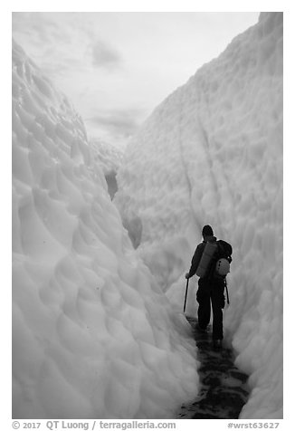Hiker in narrow canyon, Root glacier. Wrangell-St Elias National Park (black and white)