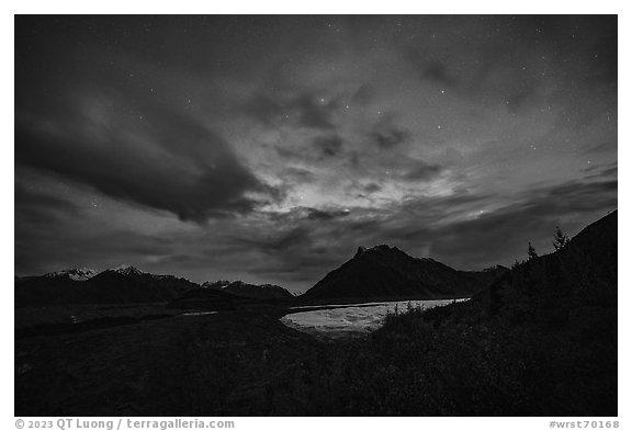 Root Glacier and Donoho Peak at night with stars, clouds, and northern lights. Wrangell-St Elias National Park (black and white)