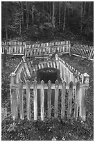 Headstone in grave fenced with white pickets, Kennecott cemetery. Wrangell-St Elias National Park ( black and white)