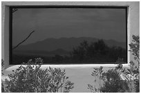 Chisos mountains, Persimmon Gap visitor center window reflexion. Big Bend National Park, Texas, USA. (black and white)