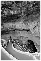 Tourist walking down natural entrance. Carlsbad Caverns National Park, New Mexico, USA. (black and white)