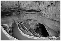 Tourists walking down natural entrance. Carlsbad Caverns National Park, New Mexico, USA. (black and white)