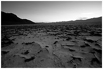 Evaporation patterns on salt flats near Badwater, dusk. Death Valley National Park, California, USA. (black and white)