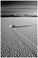 Tracks, sliding stone on the Racetrack playa, late afternoon. Death Valley National Park, California, USA. (black and white)