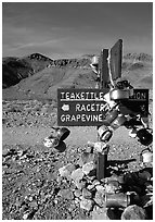 Teakettle Junction sign, adorned with teakettles. Death Valley National Park ( black and white)