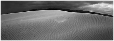 Dune and mountain in stormy weather. Death Valley National Park (Panoramic black and white)
