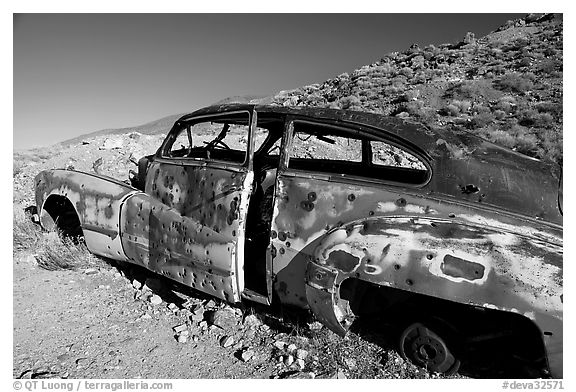 Car with bullet holes near Aguereberry camp, afternoon. Death Valley National Park (black and white)