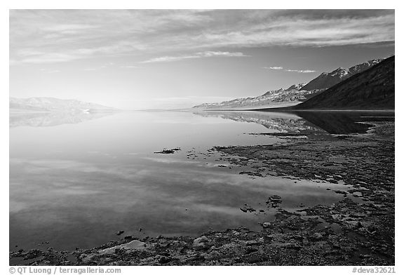 Flooded Badwater basin and Black mountain reflections, early morning. Death Valley National Park (black and white)