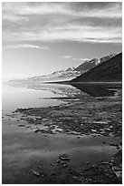 Black mountain reflections in flooded Badwater basin, early morning. Death Valley National Park ( black and white)