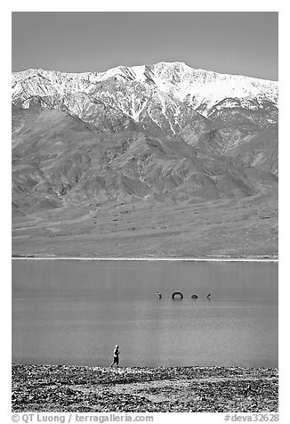 Tourist, ephemeral Loch Ness Monster in Manly Lake, and Telescope Peak. Death Valley National Park, California, USA.