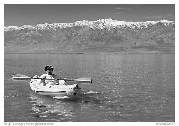 Kayaker padding ephemeral Manly Lake. Death Valley National Park (black and white)