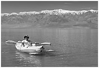 Kayaker padding ephemeral Manly Lake. Death Valley National Park ( black and white)