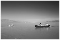 Canoists and kayaker on the flooded floor. Death Valley National Park, California, USA. (black and white)