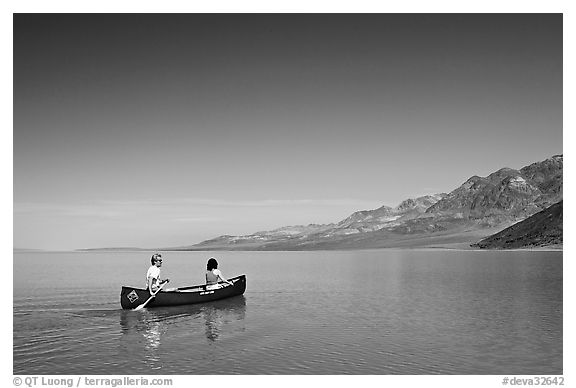 Canoeing on the ephemerald Manly Lake with Black Mountains in the background. Death Valley National Park (black and white)