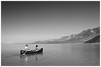 Canoeing on the ephemerald Manly Lake with Black Mountains in the background. Death Valley National Park ( black and white)