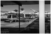 Patio, oasis and mountains, Furnace Creek Visitor Center window reflexion. Death Valley National Park ( black and white)