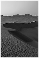 Sand dunes and Amargosa Range at dusk. Death Valley National Park ( black and white)